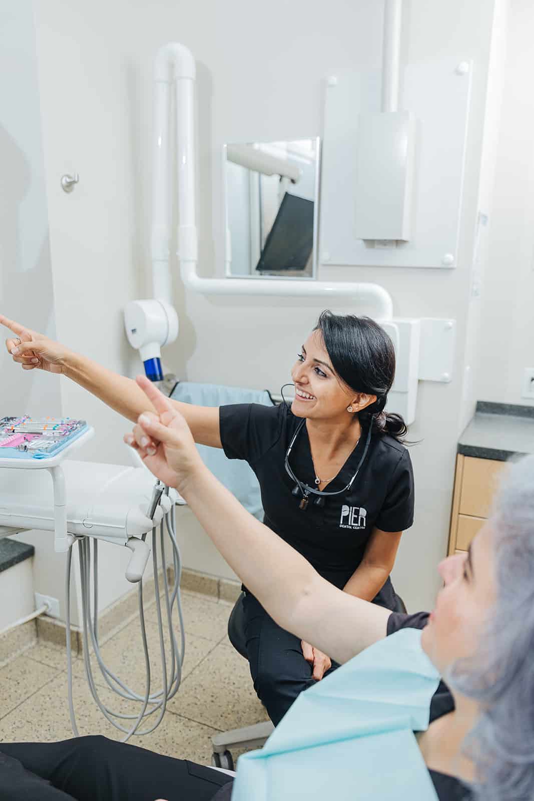 an image of a dental hygienist talking to a patient in a dentist office in north vancouver